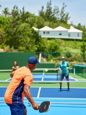 A group of people are playing pickleball