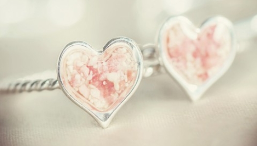 Two pink sand heart rings.