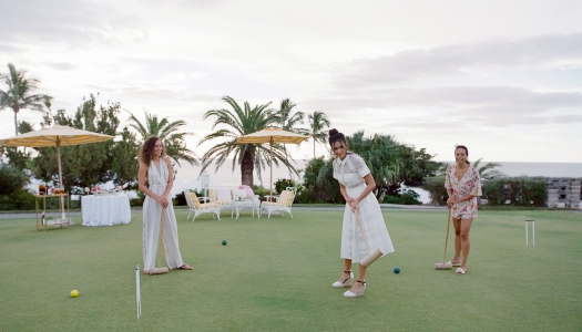A group of women are playing croquet.