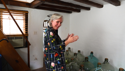 Isabel is in an old Bermuda building with her perfume bottles.