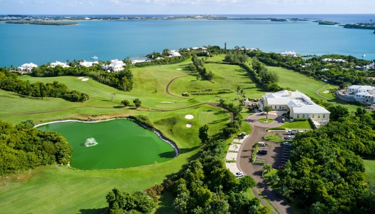 Aerial view of Tucker's Point golf course with a pond and green fairways.