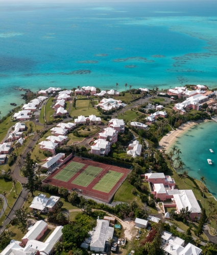 Aerial view of Cambridge Beaches with tennis courts, beach and boats.