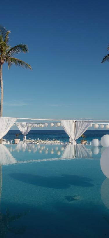 Balloons resting on an infinity pool