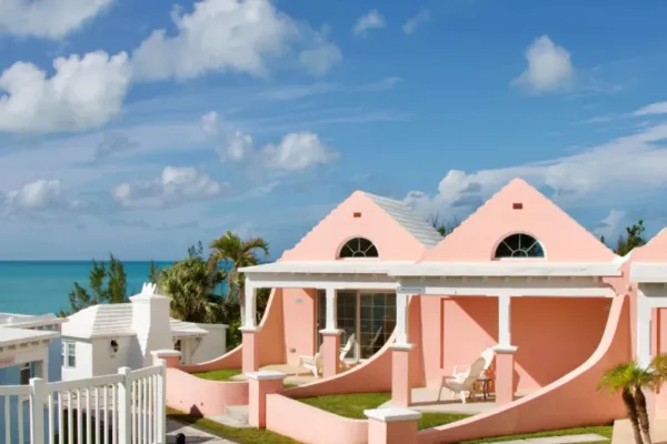 The exterior of Willowbank resort, with coral-coloured suites in view of the ocean