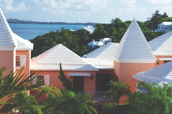 The Exterior of Mid Ocean Club, with terra cotta building topped with white roofs