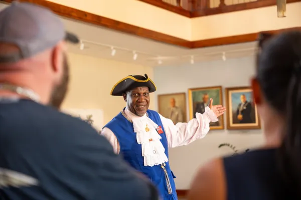 Bermuda town crier Ed Christopher gives patrons a tour of a gallery