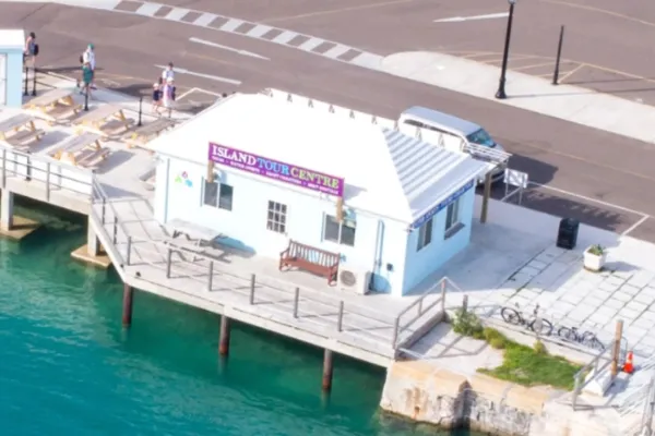 The office of Bermuda's Island Tour Centre, a white building on a boardwalk