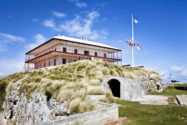The Commissioner's House sits on a rocky bluff with blue skies in the background