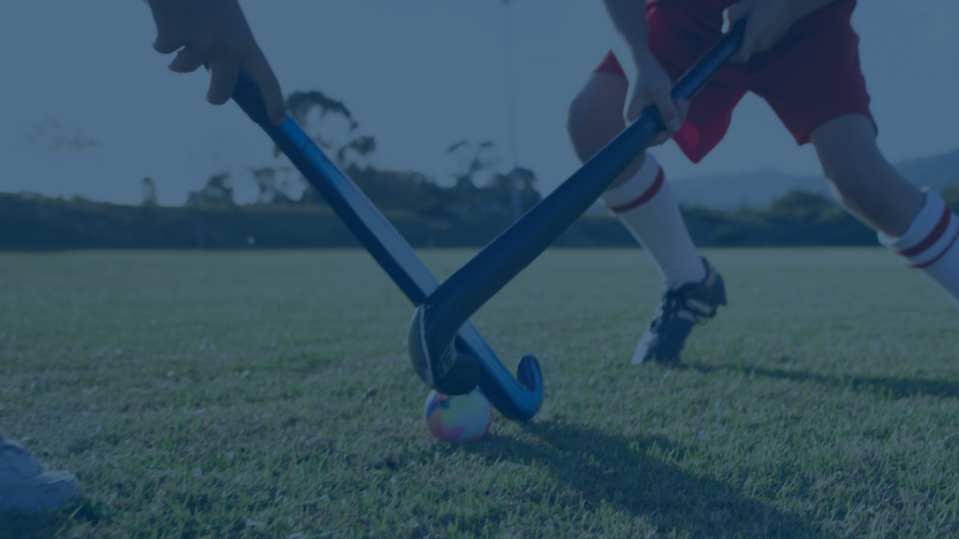 Close up of two field hockey sticks battling for the ball