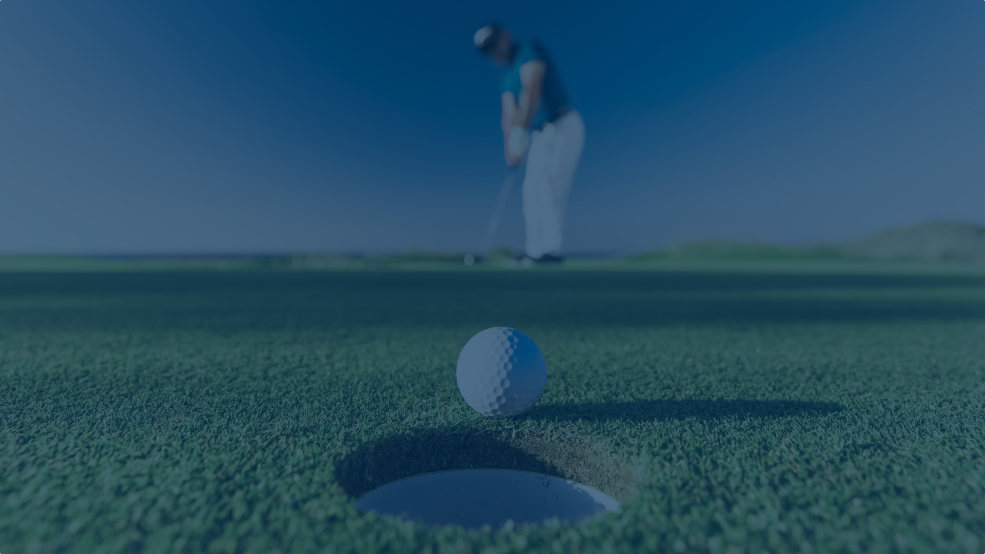 Closeup of golf ball going into the hole after a putt