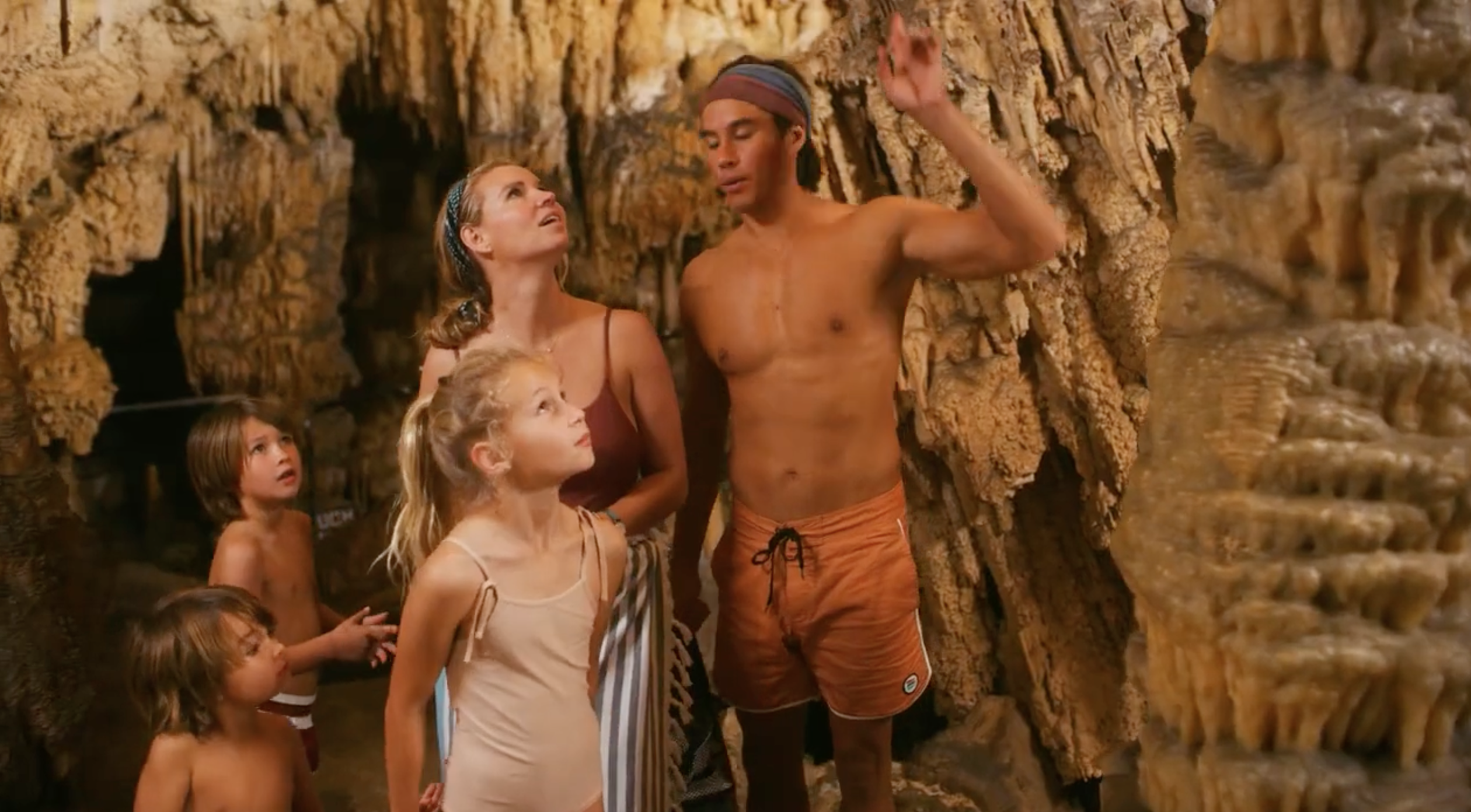 A family is staring at the ceiling in local Bermuda caves.