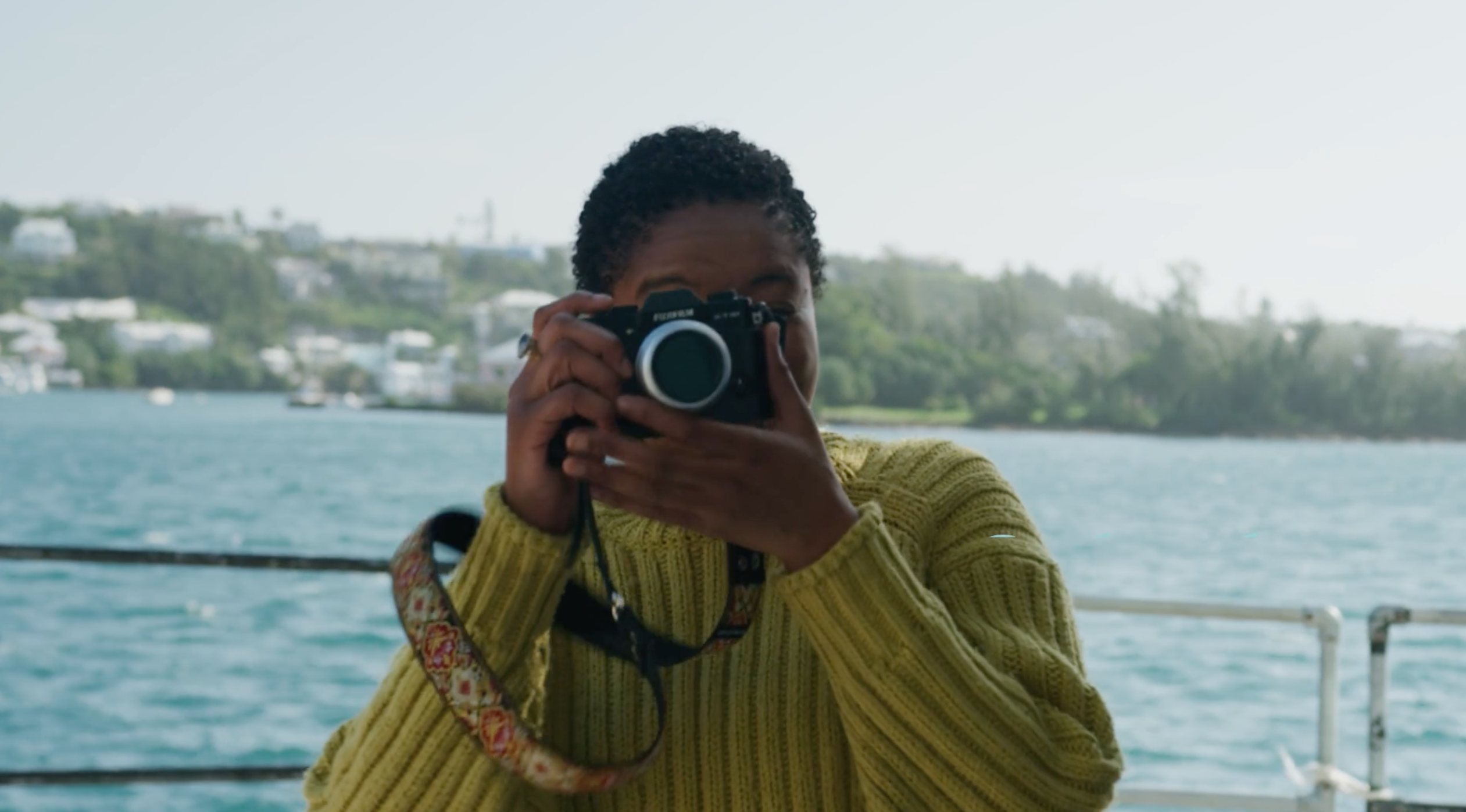 A woman is pointing her camera at the camera.