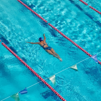 Aerial shot of woman swimming laps at the National Stadium pool