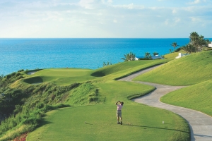 Man teeing off at Port Royal Golf Course with a view of the ocean