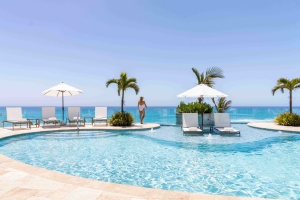 A woman is staring out at the ocean at Azura Bermuda.