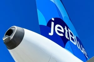 View of JetBlue tail with blue skies.