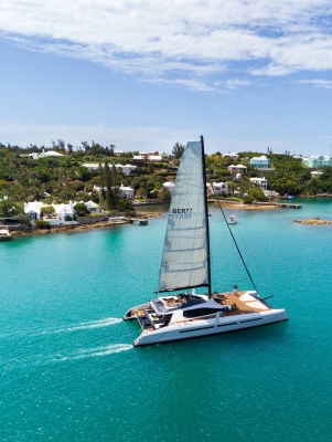 private sail boat gliding along the coastline