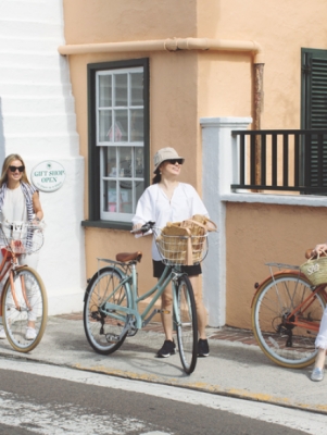Four women walking their bikes