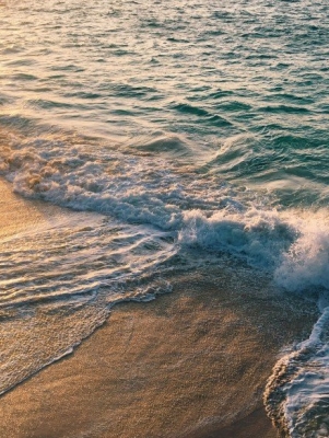 waves of the ocean going on to sand