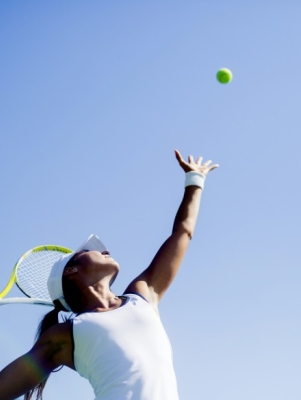 tennis player serving ball