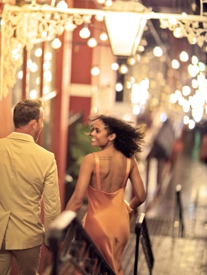 A couple running through the streets of Bermuda at night.