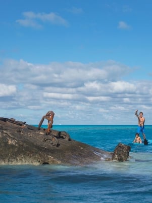 Family paddleboarding near the HMS Vixen