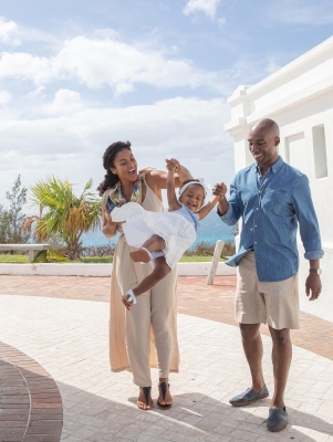 Family swinging their daughter in Bermuda