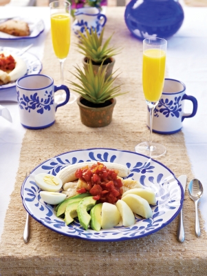 A traditional codfish breakfast with mimosas and colourful plate.