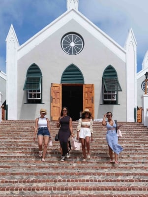 A group of friends are walking out of a church.