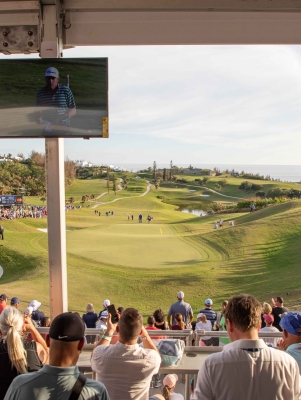 People watching the Butterfield Golf Championship on a calm day.