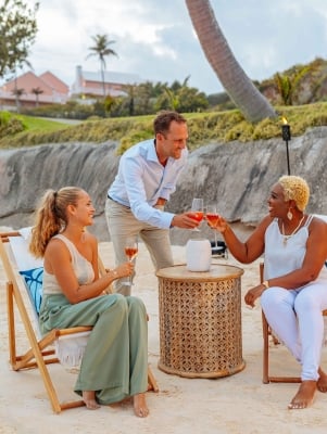 A group are cheerings at the Hamilton Princess Beach Club.