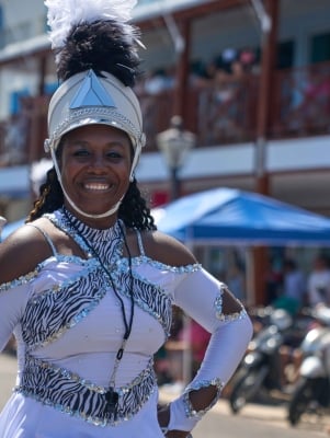 A woman is a costume is smiling at Bermuda Day.