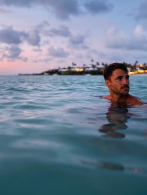 A man is swimming at the beach.