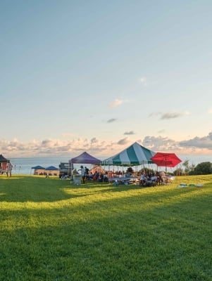 A family are camping by the waterside at Cup Match.