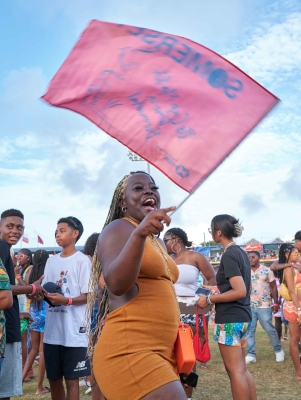 A woman is smiling with a somerset flag.