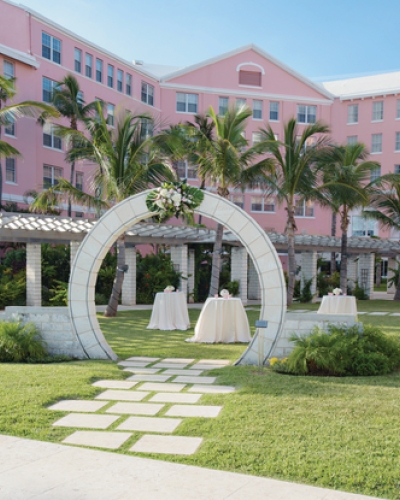 A moongate with a wedding setup in the Hamilton Princess courtyard 