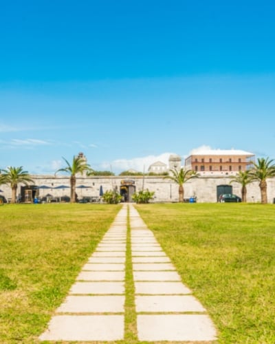 Stone pathway in the grass leading to a building