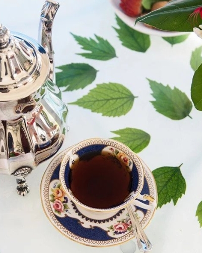 cup of tea with teapot on table