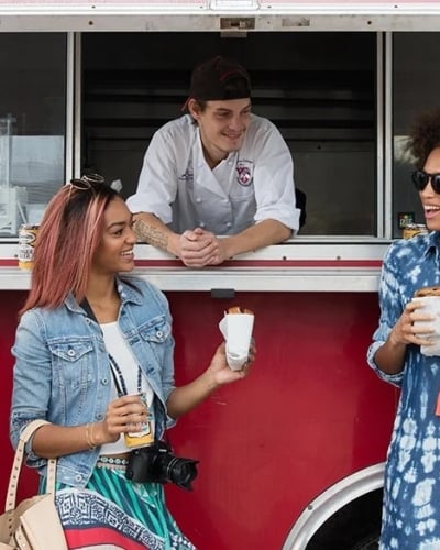 people in front of a food truck