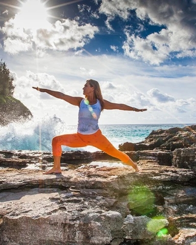 woman doing yoga on rocks