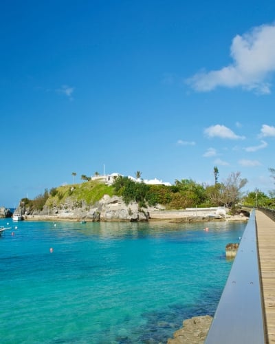 wooden bridge crossing over a body of water along the Bermudian coastline