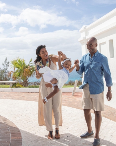 Family swinging their daughter in Bermuda