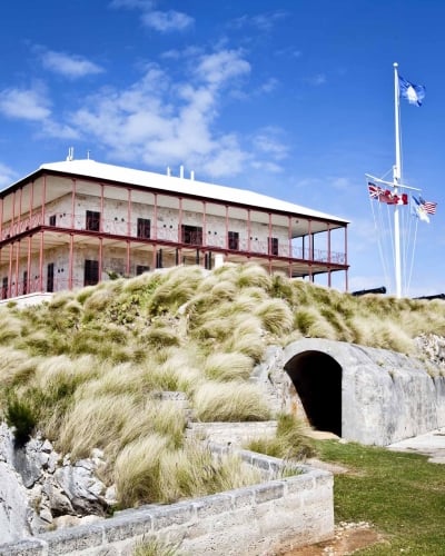 The Commissioner's House sits on a rocky bluff with blue skies in the background