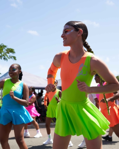 A group of dancers are dancing on Front Street
