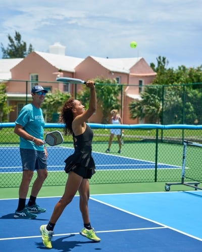 Two people are on a court playing pickleball