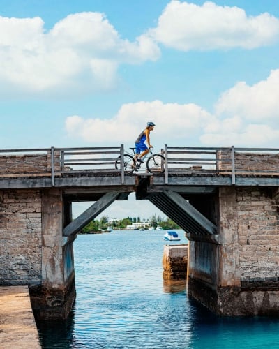 A man is cycling over Somerset Bridge