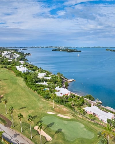 Aerial of newstead belmont hills with a sail boat floating by.