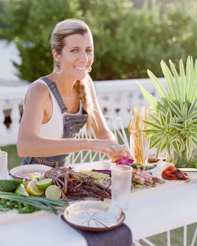 A woman is posing preparing food.
