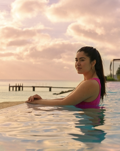 A woman is smiling in a pool