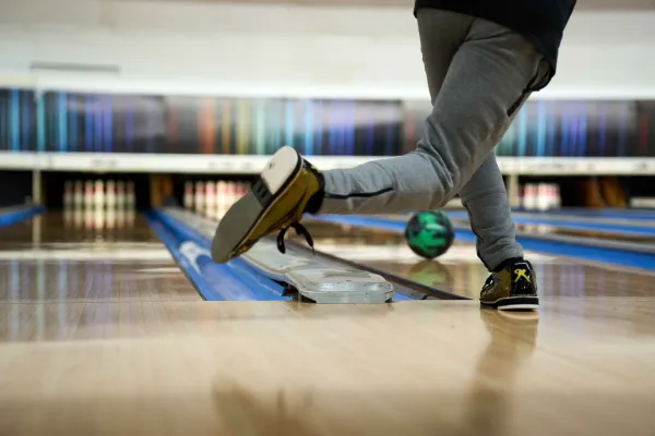 A person throwing a bowling ball